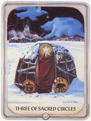 the three sacred circles tarot card is in front of an image of a snowy landscape