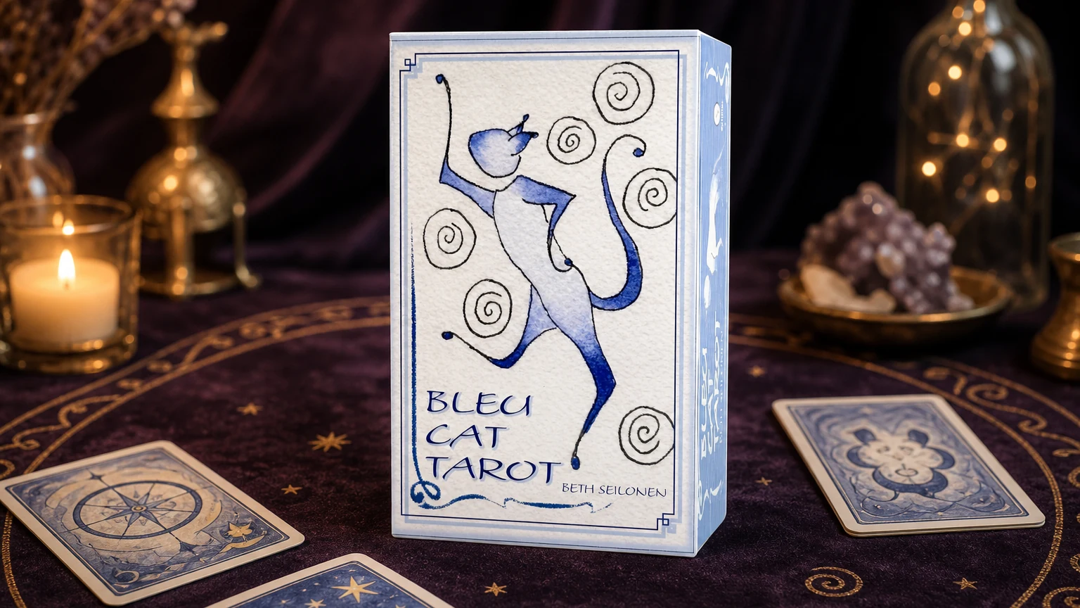 Bleu Cat Tarot product box lifestyle image Bleu Cat Tarot product box on a plum and gold tarot table