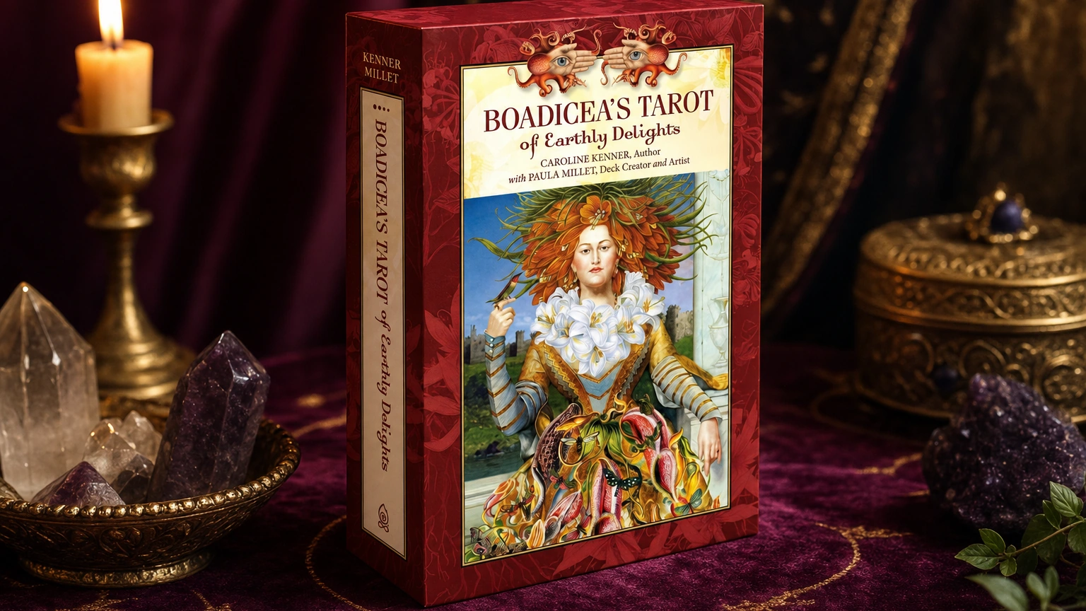 Boadicea’s Tarot of Earthly Delights product box lifestyle image Boadicea’s Tarot of Earthly Delights product box on a plum and gold tarot table
