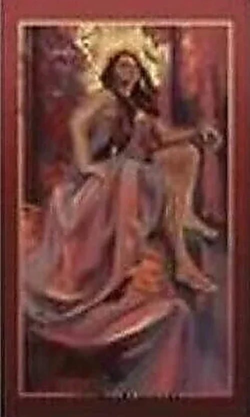 A softly blurred Empress card with a seated feminine figure in warm rose tones.