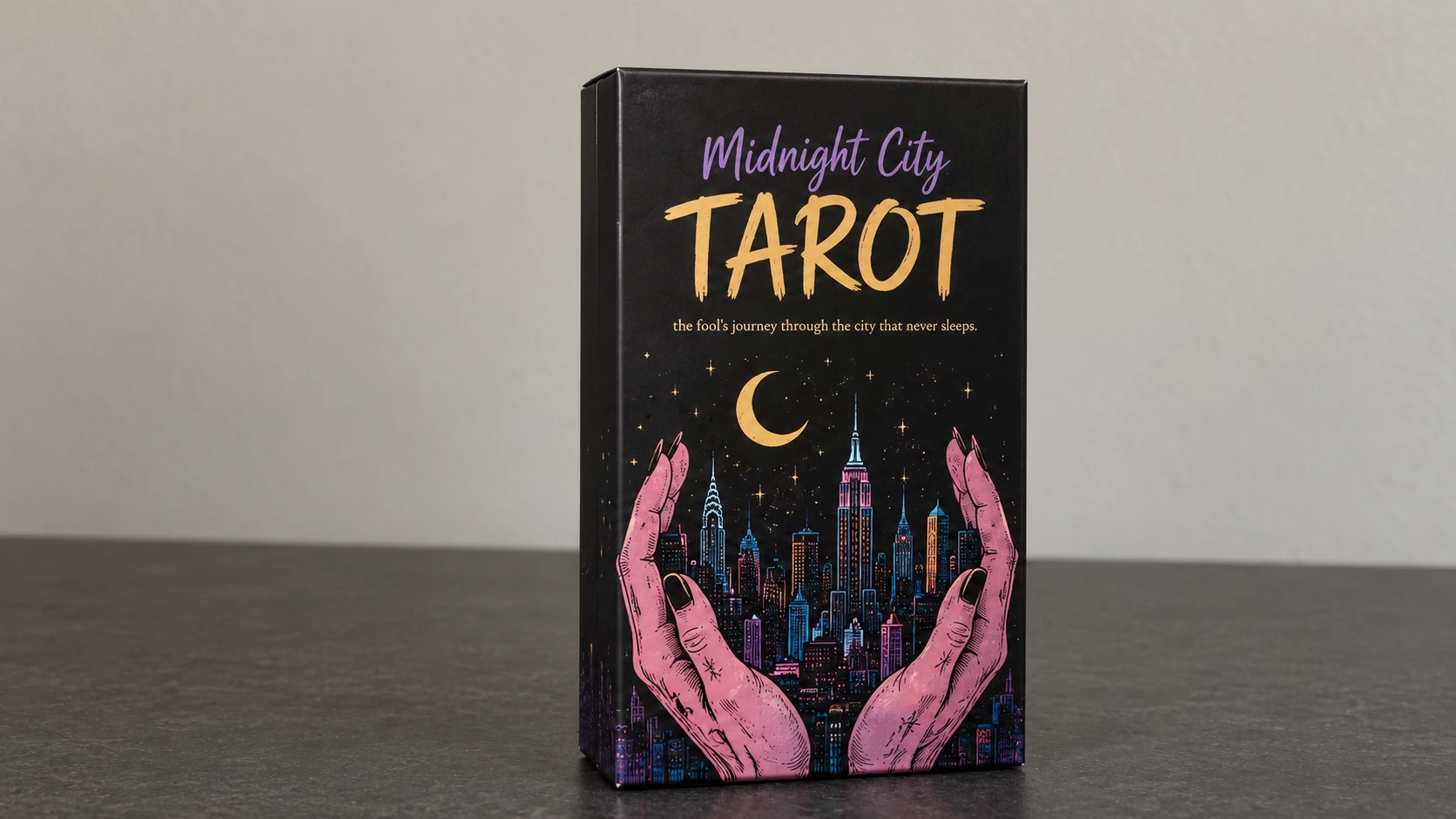 Midnight City Tarot Deck by Jackie Gillies Generated illustrative scene of the Midnight City Tarot box against a plain wall on a matte tabletop