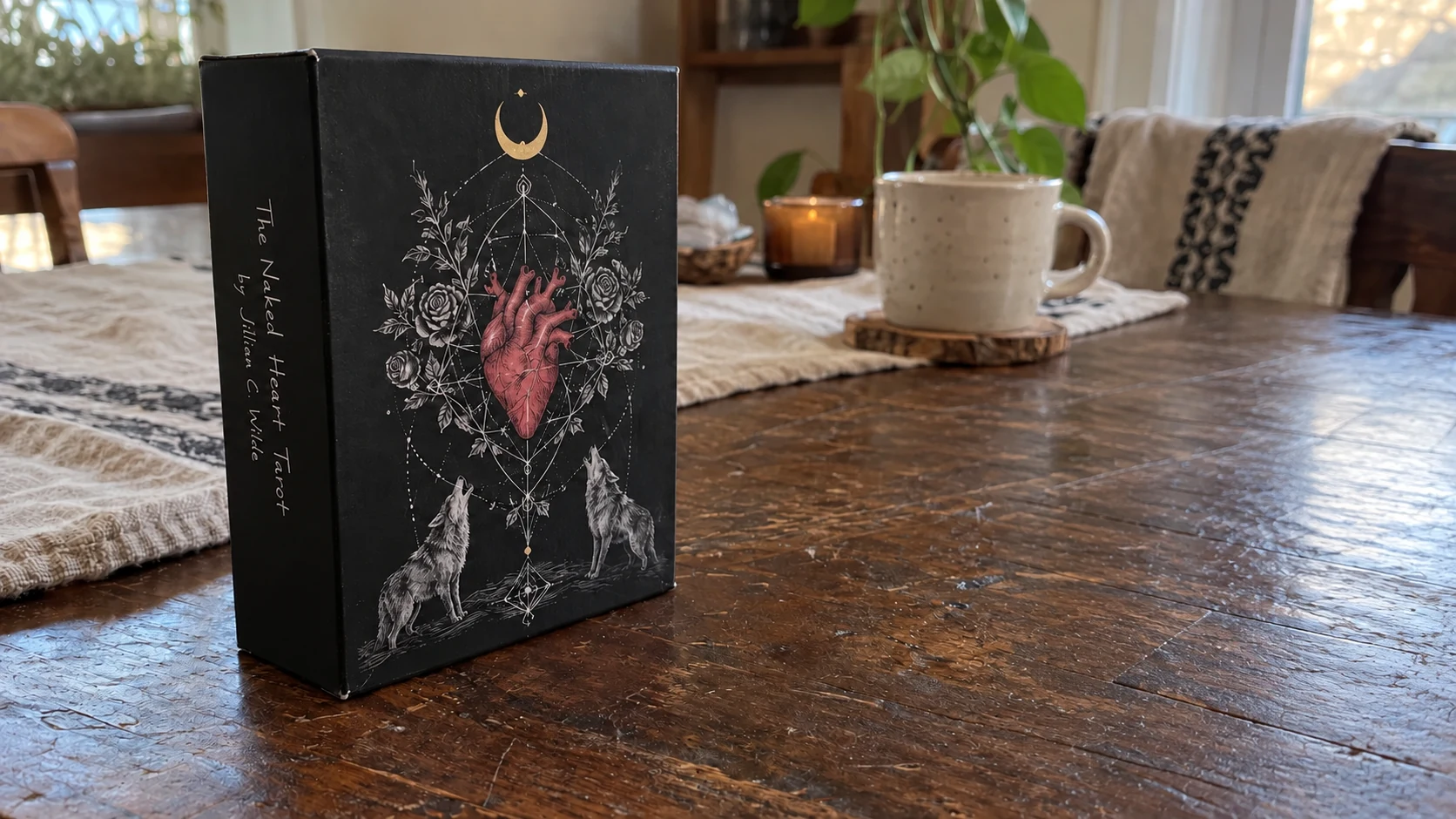 AI-generated editorial scene of The Naked Heart Tarot Deck by Jillian C. Wilde, with its box alone on a wooden reading table