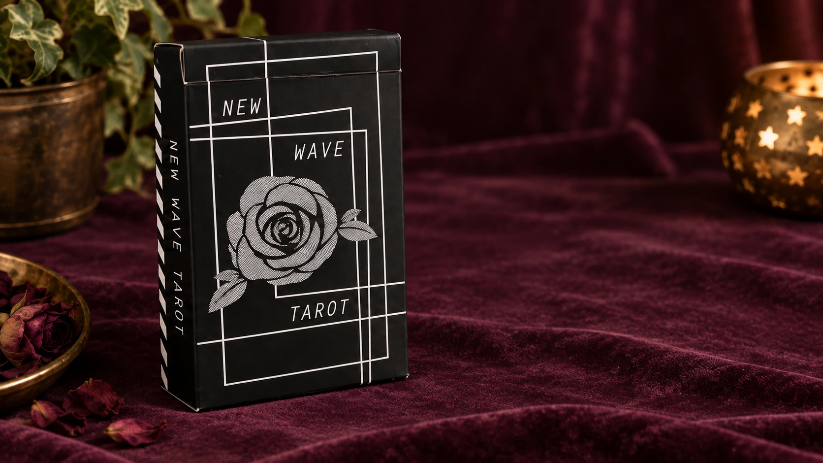 The New Wave Tarot V2 Deck by Amanda Lee Stilwell black rose box on a burgundy velvet table in a generated lifestyle photo