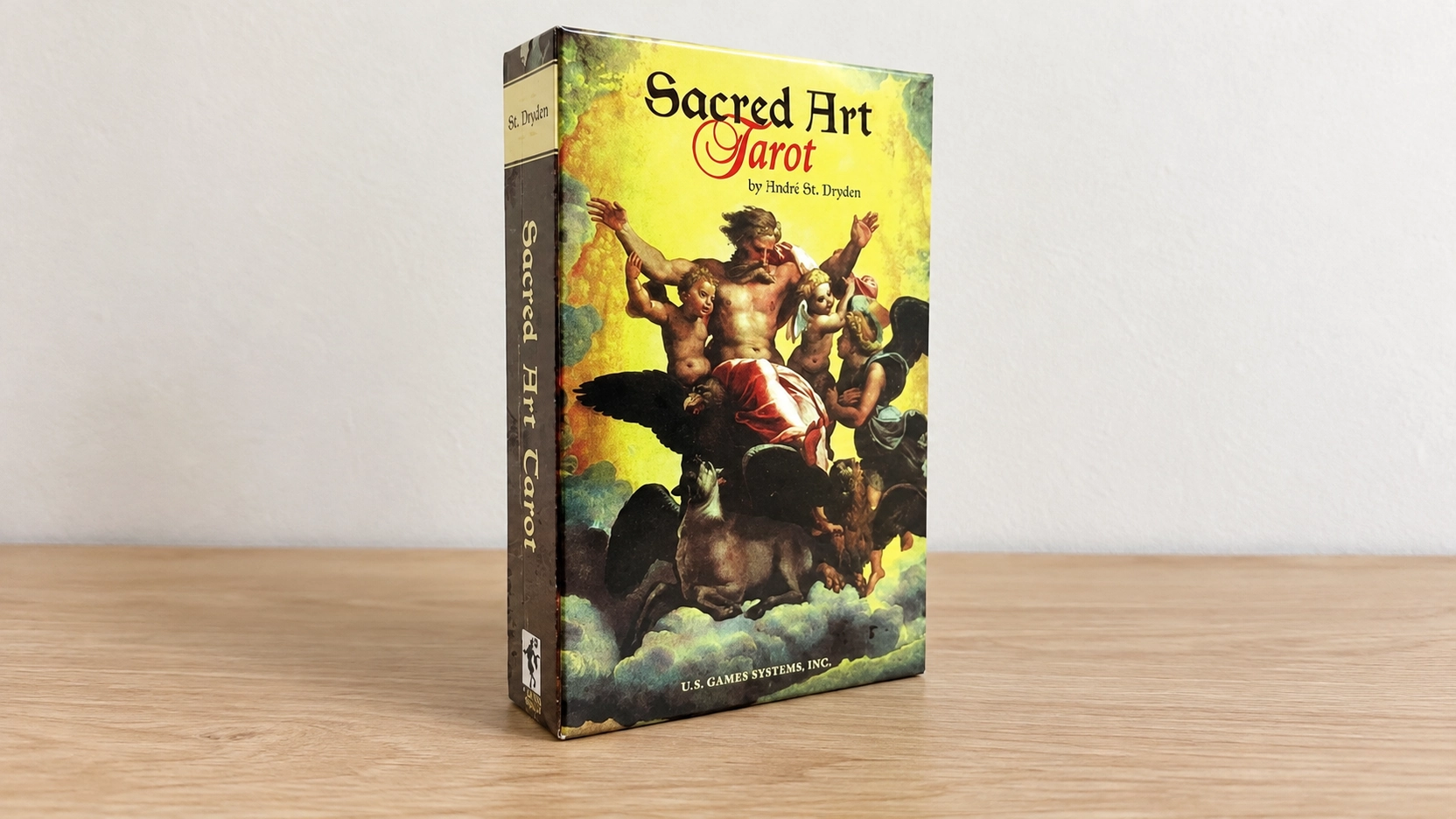 Generated photograph of the Sacred Art Tarot box by André St. Dryden standing alone on a bare table against a neutral wall