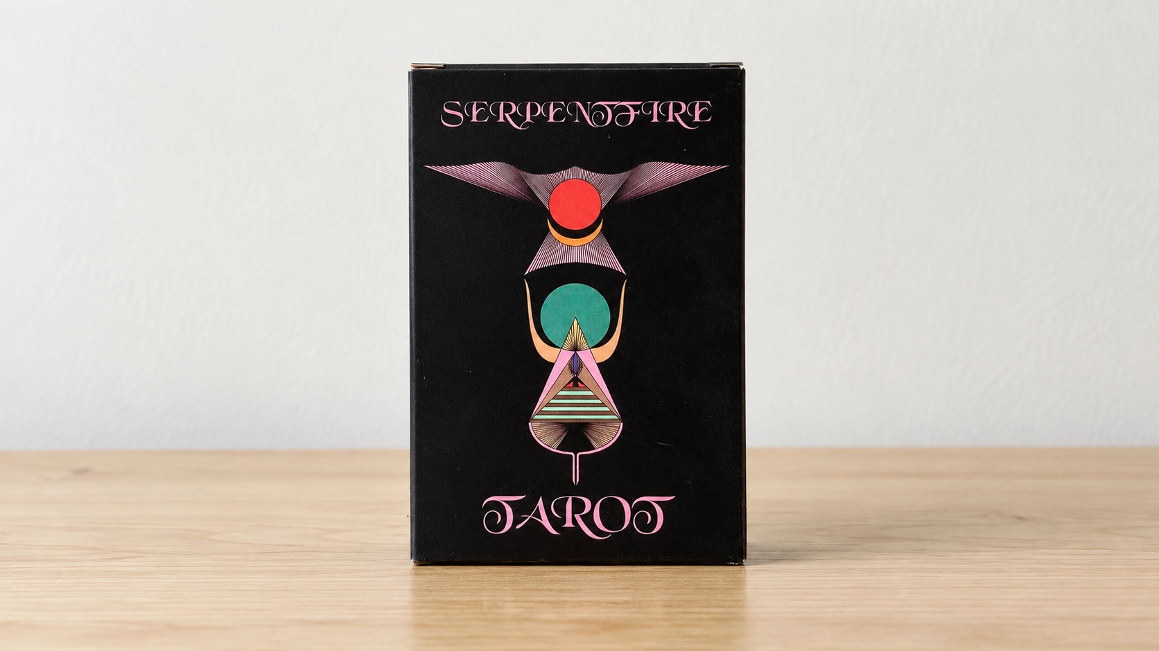 Generated product scene of one Serpentfire Tarot final 7th edition box on a bare table against a neutral background