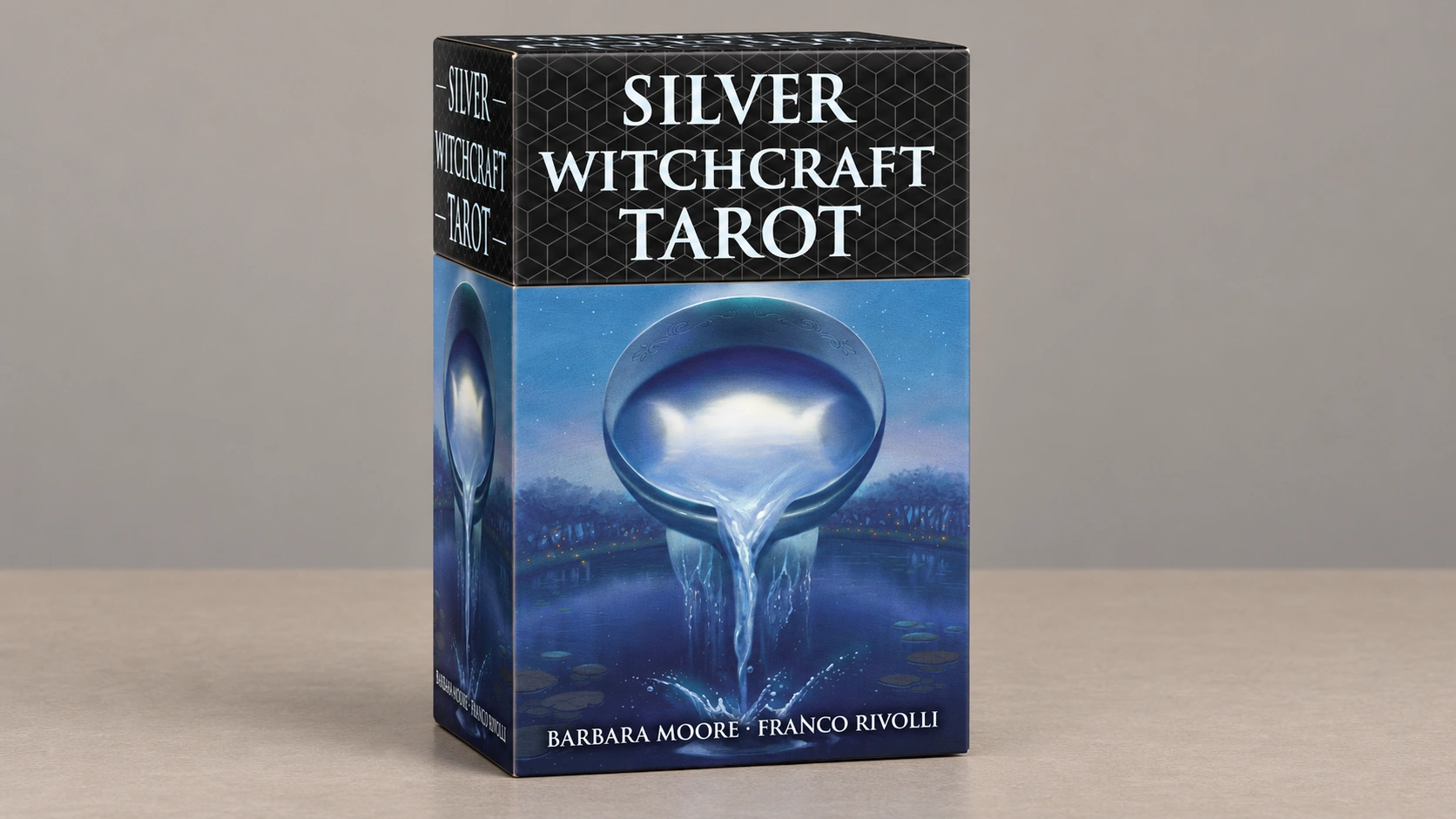 Generated product scene of one Silver Witchcraft Tarot premium box on a bare table against a plain neutral background