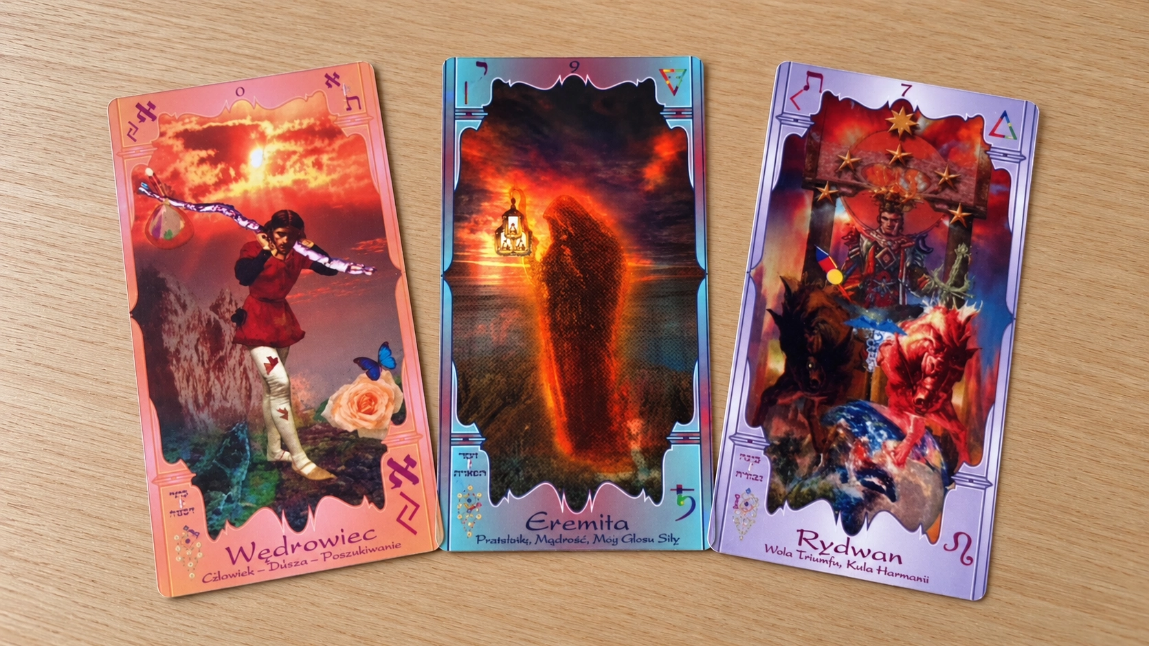 Generated editorial scene of three Soul Mandala Tarot cards by Dariusz Cecuda lying face up on a bare wooden table