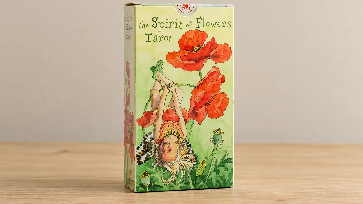 Generated editorial visualization of one closed Spirit of Flowers Tarot box on a bare wooden table against a plain wall, based on the supplied Lo Scarabeo packaging reference