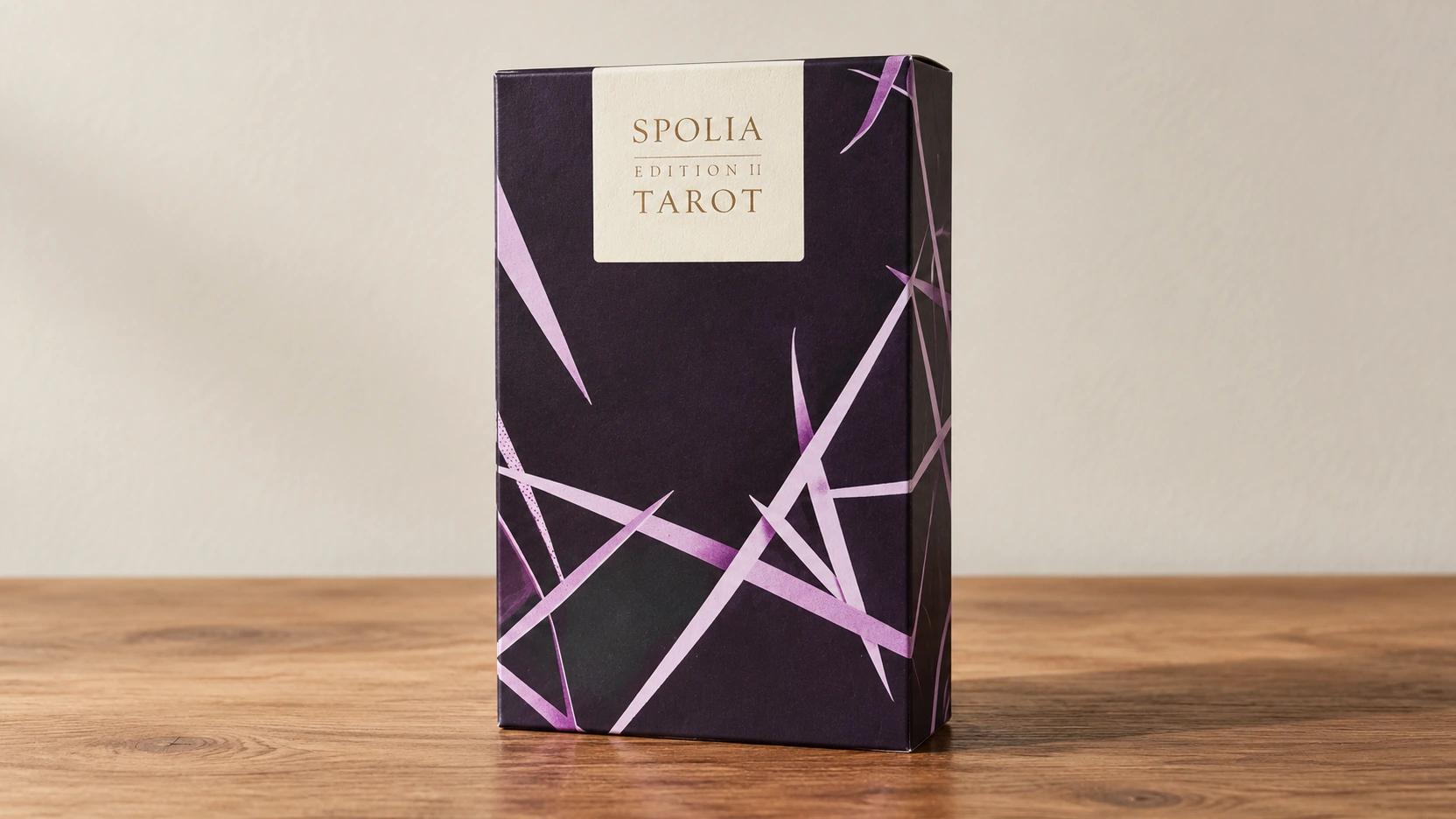 Generated product scene showing the documented dark purple patterned Spolia Tarot Edition II box on a plain wooden table