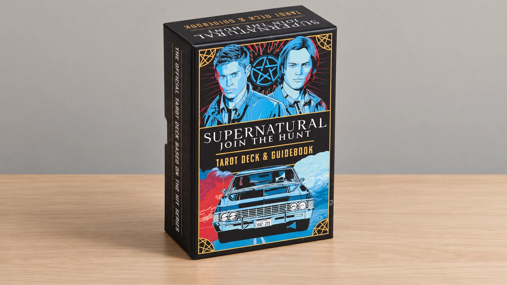 AI-generated editorial illustration of the closed licensed Supernatural Tarot Deck and Guidebook box alone on a plain wood table