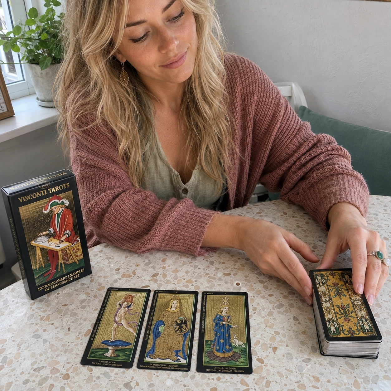 Aurica arranging Visconti Tarot beside its box, a three-card spread, and stacked deck
