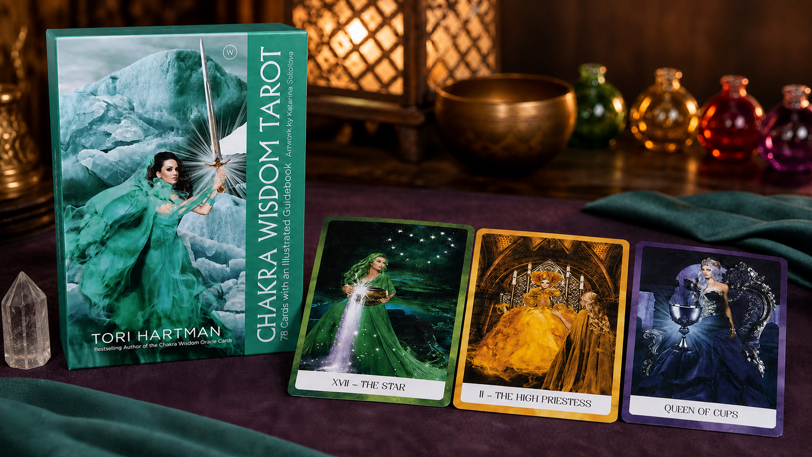 Chakra Wisdom Tarot Deck by Tori Hartman, with its box and three cards arranged in a warm reading nook